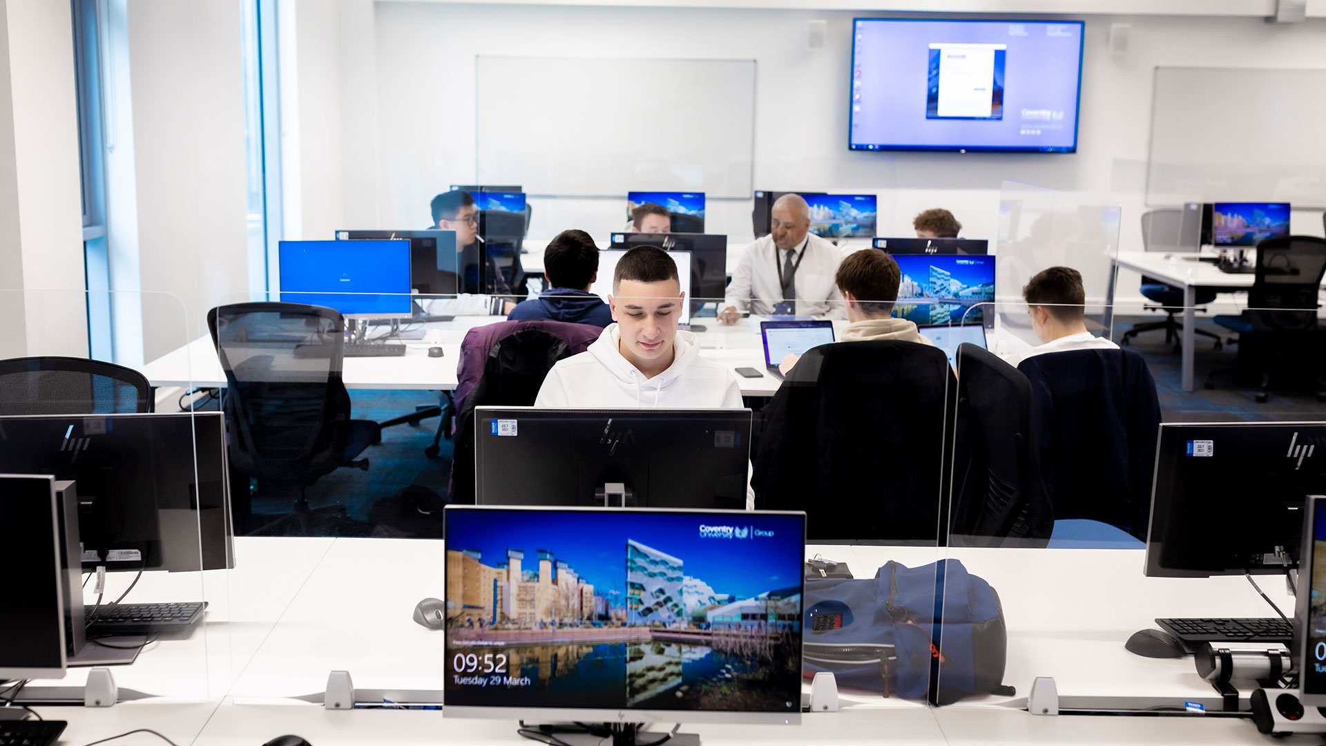 Students working on desktops in a computer lab.