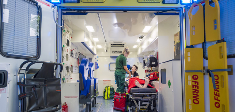 Students practicing patient care in an ambulance