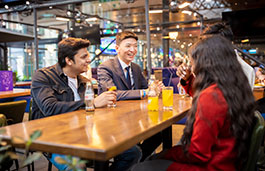 Two people laughing in an outdoor bar area