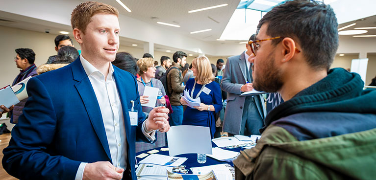 student talking to a recuiter at a career fair