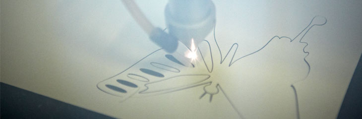 A laser cutting machine cutting a butterfly shape