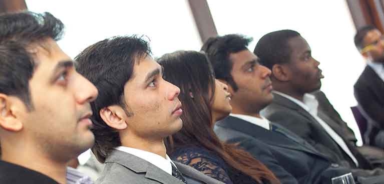row of five people in business suits looking forward