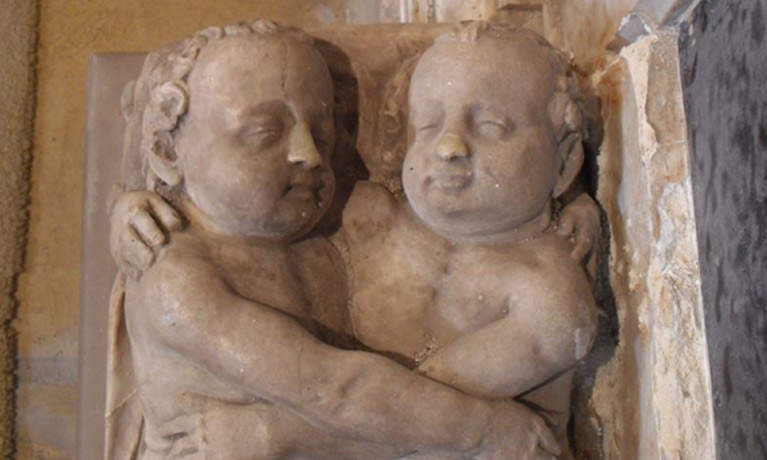 a statue of two babies embracing