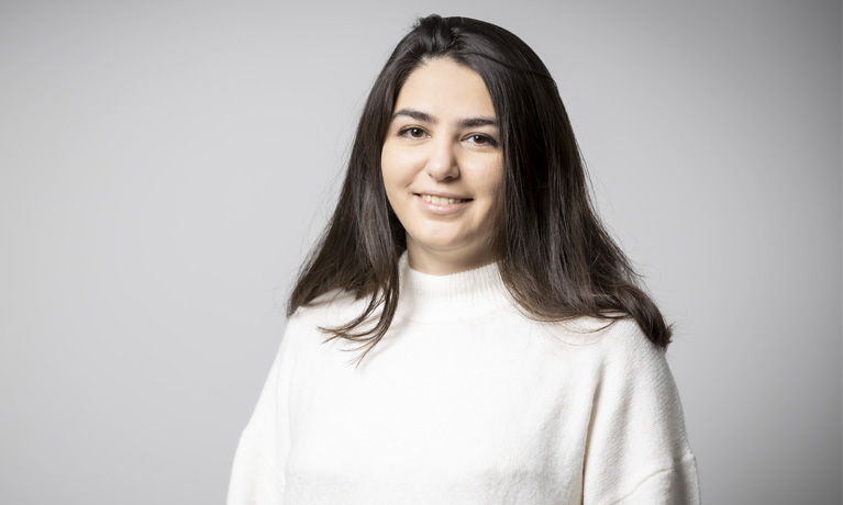 Sara Sardari smiling wearing white jumper