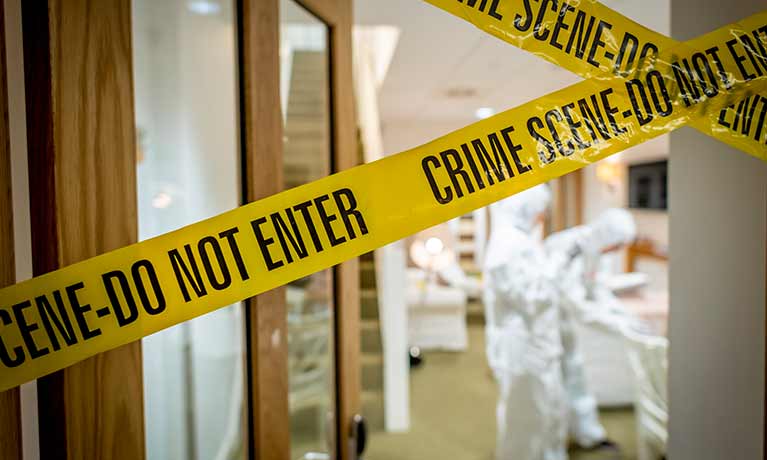 Forensic crime scene tape over an open door