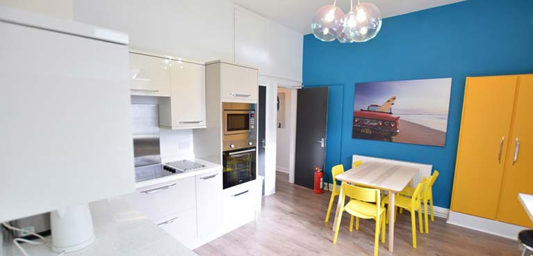 Kitchen worktops and oven and dining table and chairs inside Aberdeen House