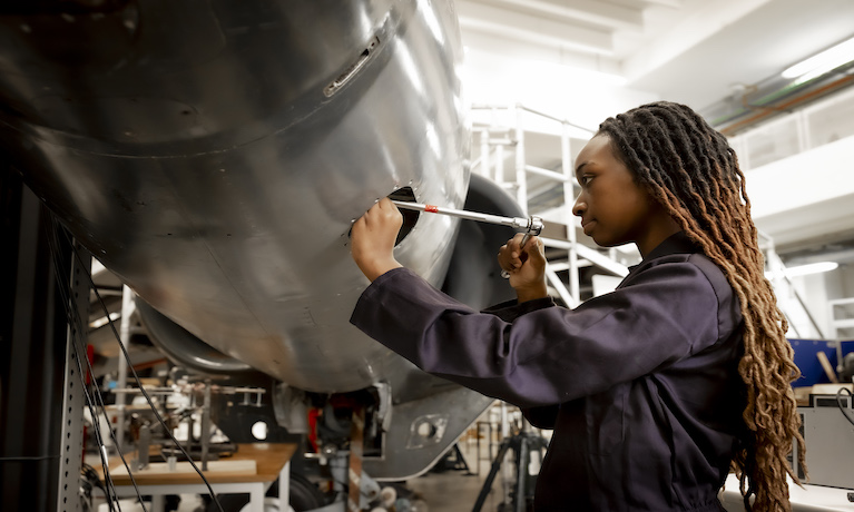 Female student working on harrier jet