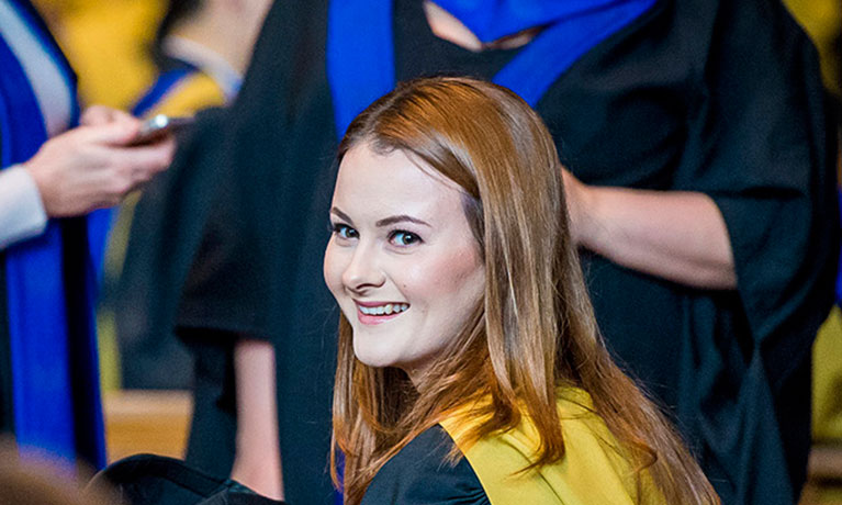 Girl smiling during her graduation  ceremony