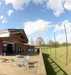 Outside view of The Place, with patio seating and views over the sports pitches