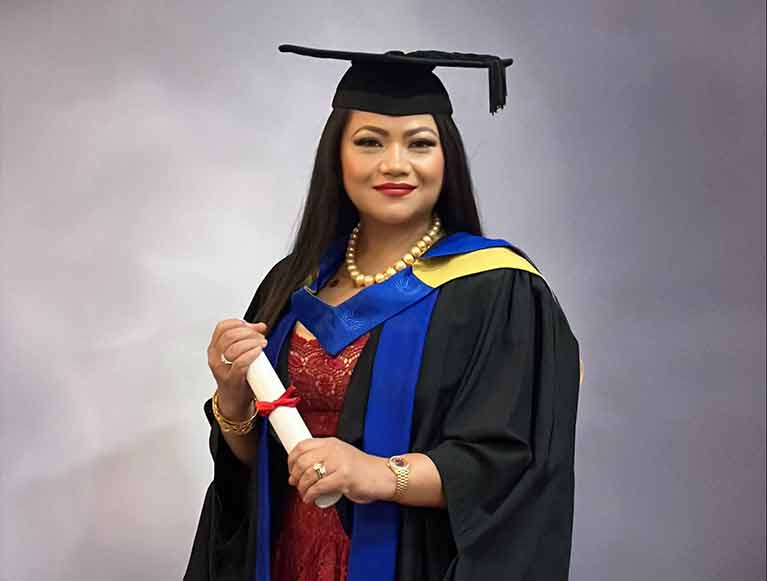 May Parsons holding her Diploma