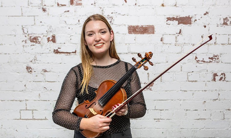 Woman holding a Violin