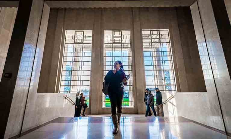 Students walking into CU London marble area