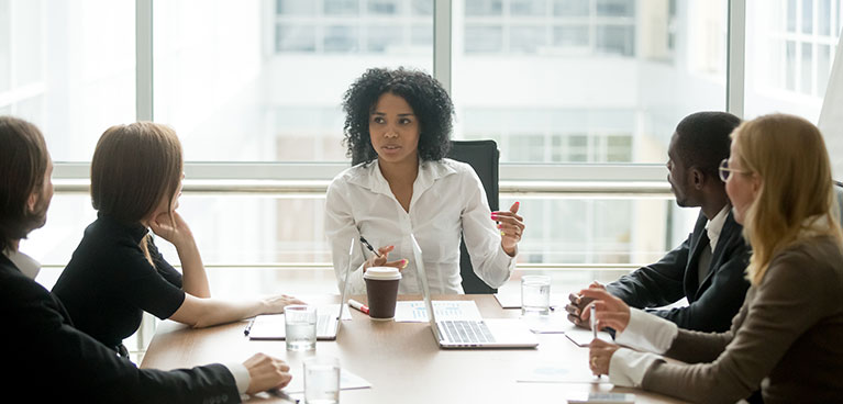 Woman leads a discussion in a boardroom