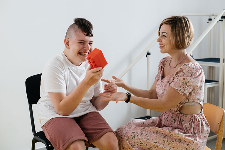  Boy with cerebral palsy having rehabilitation, learning, building. Mental training in medical care center