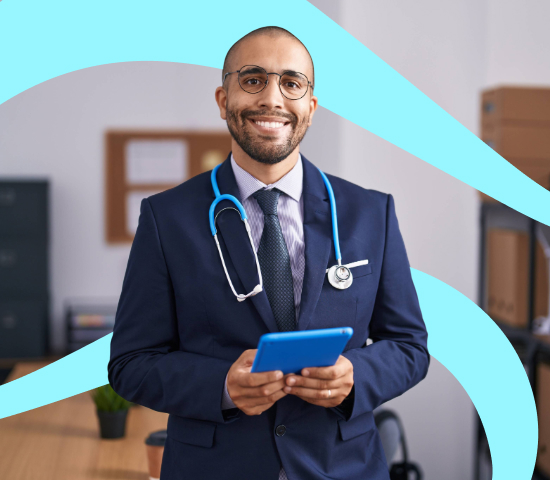 Smiling health professional in a suit with a stethoscope, holding a tablet in a modern office setting.