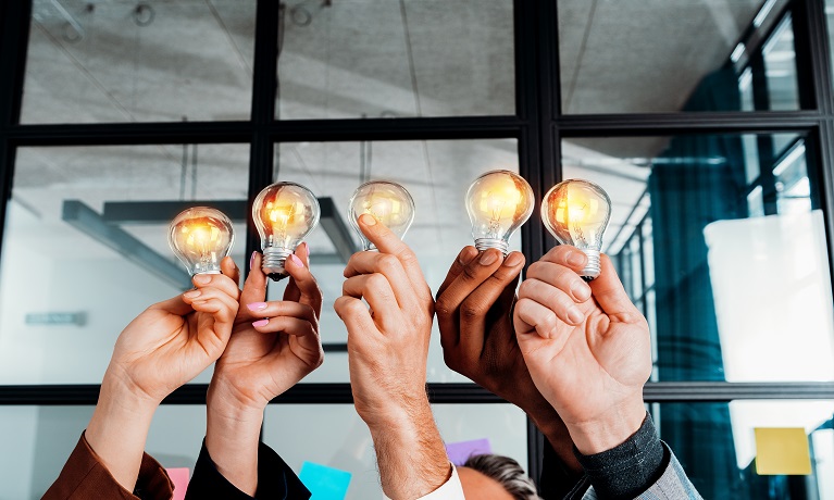 business people holding lightbulbs to represent strategic thinking
