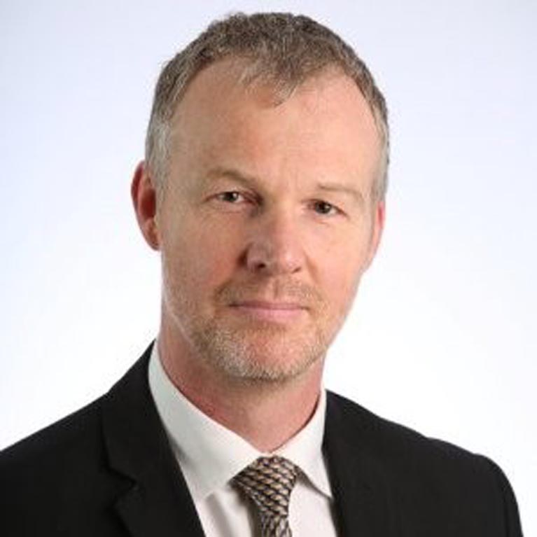 Head and shoulders photo of Kevin Vincent wearing a black suit and white shirt