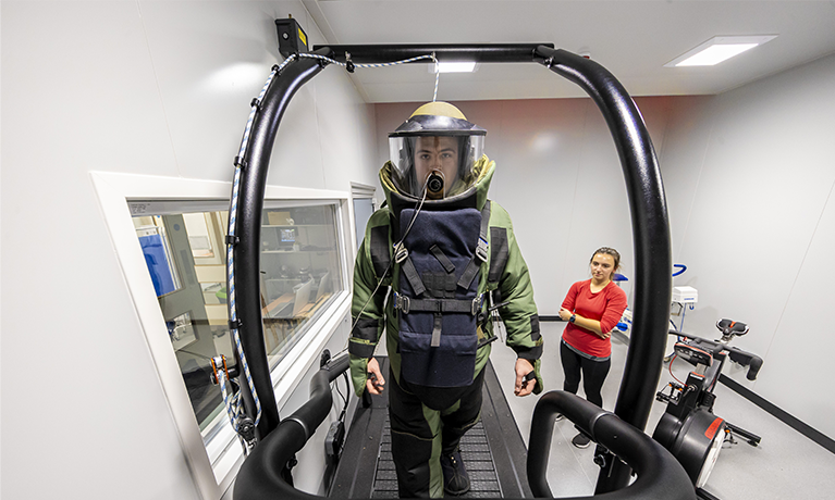 Person in a suit walking on a treadmill