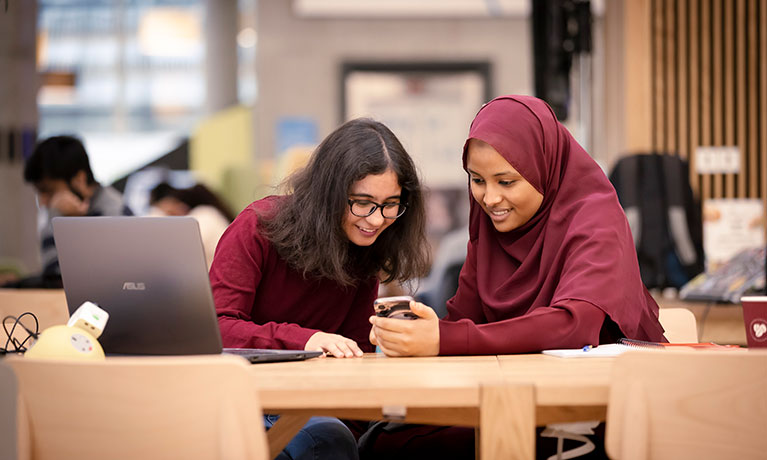 AULA illustration Two learners looking at mobile devices