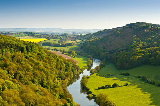 A birds eye view of of fields, trees and circular buildings