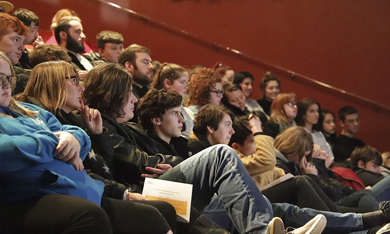 College students listening to talk in theatre