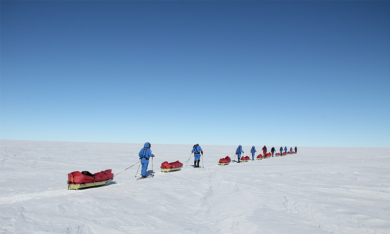 researchers walking across the South Pole
