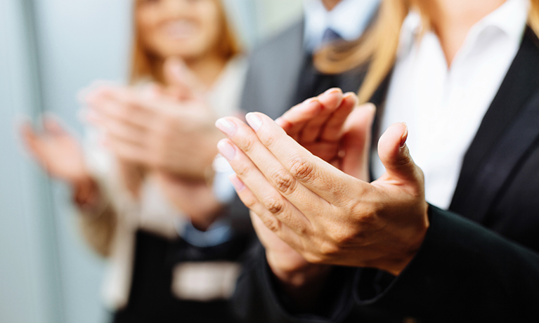 Business people clapping to celebrate an achievement