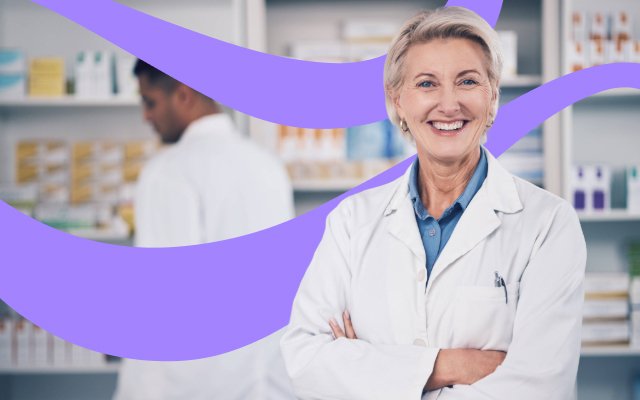 Smiling female health professional in a lab coat with arms crossed.