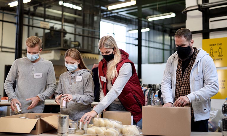 People packing food in a factory.