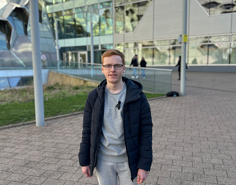 Matthew Lear standing outside of Frank Whittle building at Coventry University