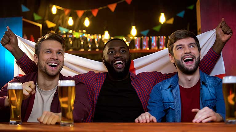 English football fans watching a game in a pub