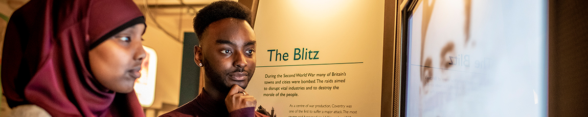 sociology students at a museum reading about The Blitz