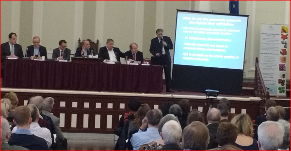 presentation taking place with people sitting and watching 