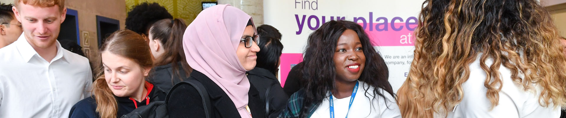 several young students at a careers event talking in different groups
