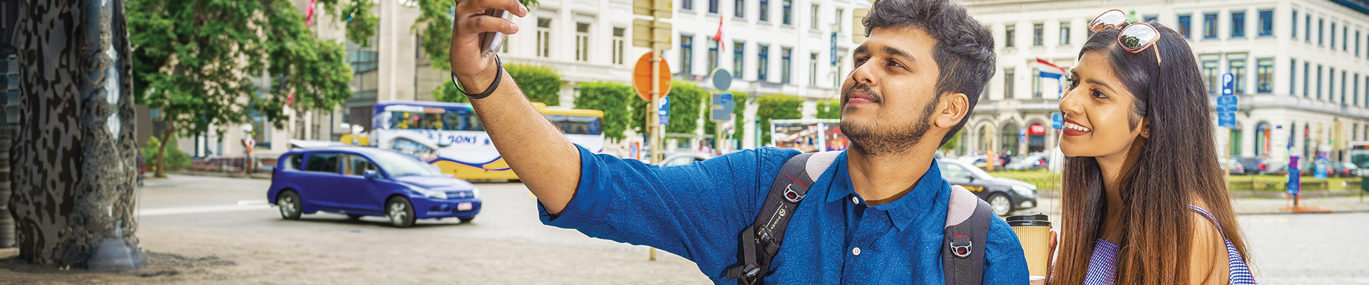 man and woman taking a selfie on an iphone