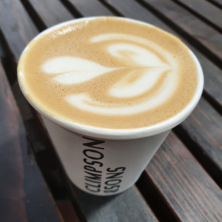 Photo of a coffee with latte art and the Climpson and Sons logo on the cup