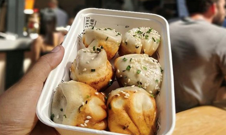 close up of dumplings in a street food container