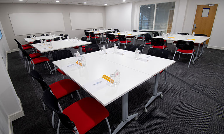 groups of tables with four chairs at each