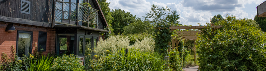 Building with plants and an arch outside