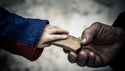 Close up of adult hand passing bread to child.