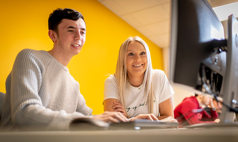 Two CU Scarborough students working at a computer