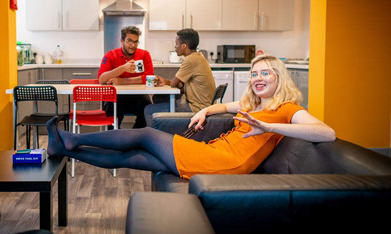 Students relaxing in a communal kitchen living area.