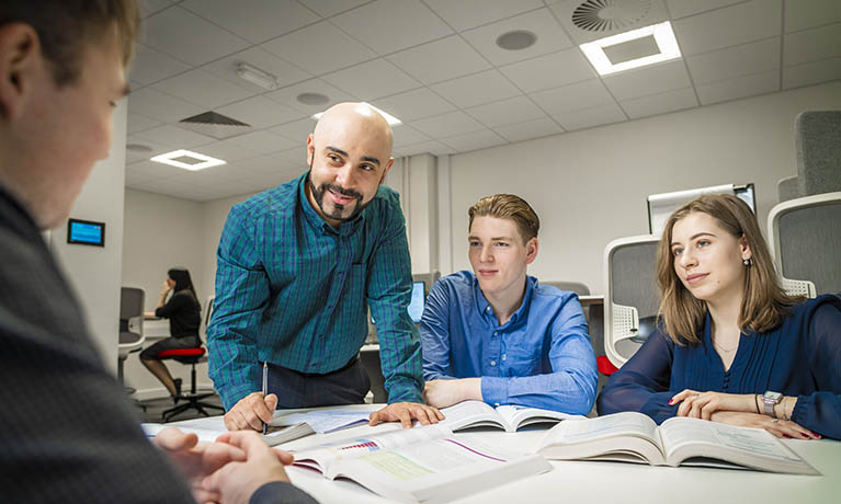 Group of students speaking with a lecturer