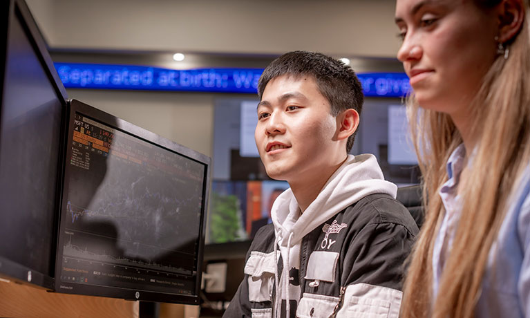 Two students working together at a computer