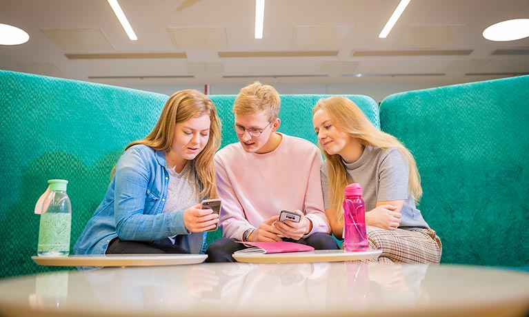 Students chatting in an open study area.