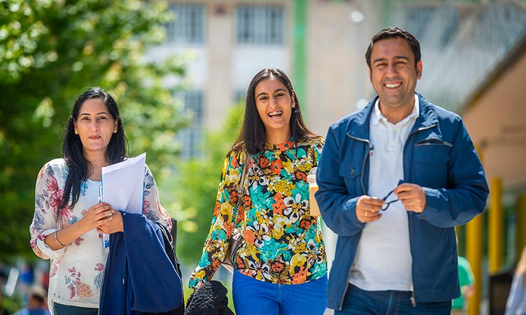 Parents and student walking through campus 