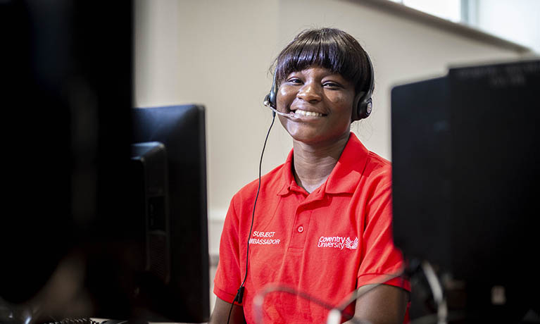 Student with headset working in the clearing call centre.