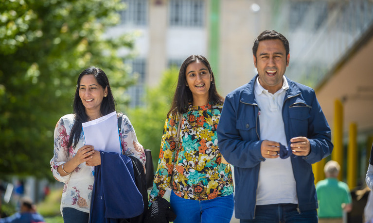 Student and her parents walking on the campus