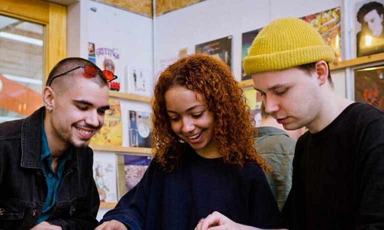 Three students in a record shop 