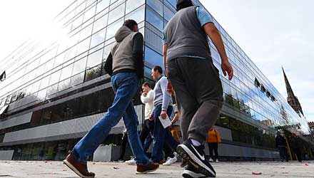 Students walking outside The Hub on a clear day.